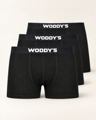 Drei schwarze Boxershorts mit kurzem Bein und weißem WODDY’S-Logo, versetzt vor warmem Off-White.